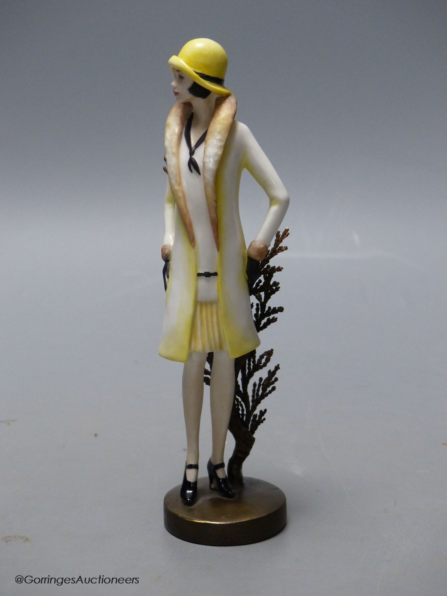 An Albany Worceter Art Deco style bronze and porcelain model of a young woman